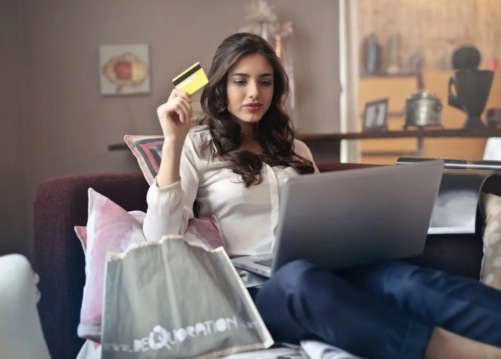 Customer on an eCommerce website with a credit card in hand