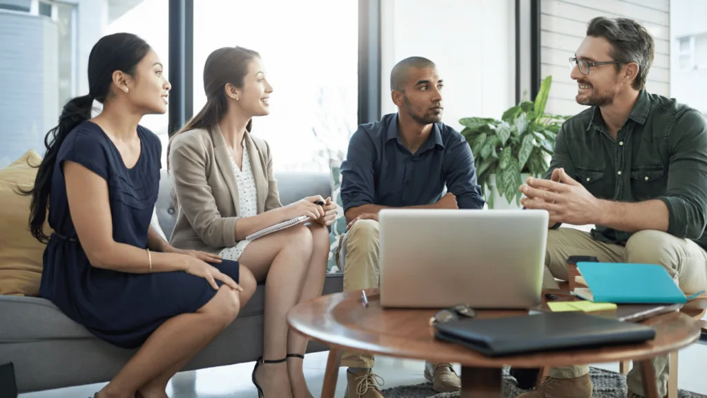 A management team discussing their options for outsourcing technical support to maximize customer satisfaction