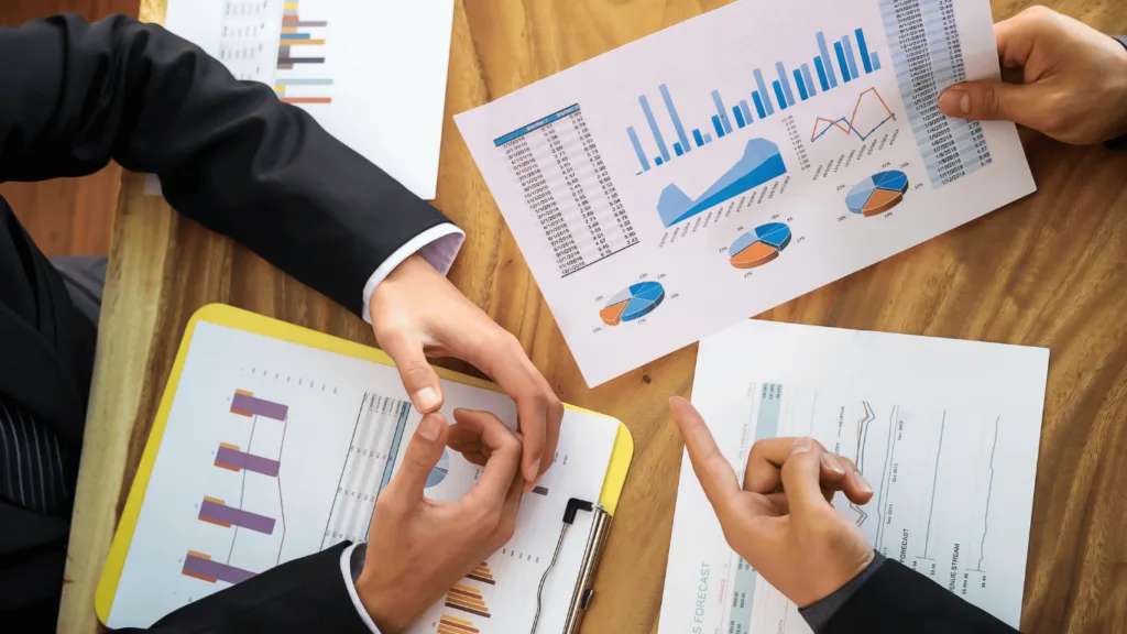 Teams discussing numbers and graphs on how bpo solutions have contributed to customer loyalty and business performance