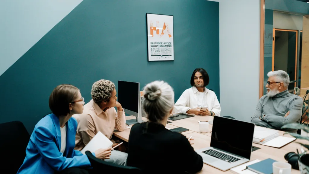 Offshore outsourcing illustrated via a business owner discussing with support staff in different locations